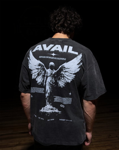 Person wearing a black t-shirt with 'AVAIL' design on the back, standing against a dark background.